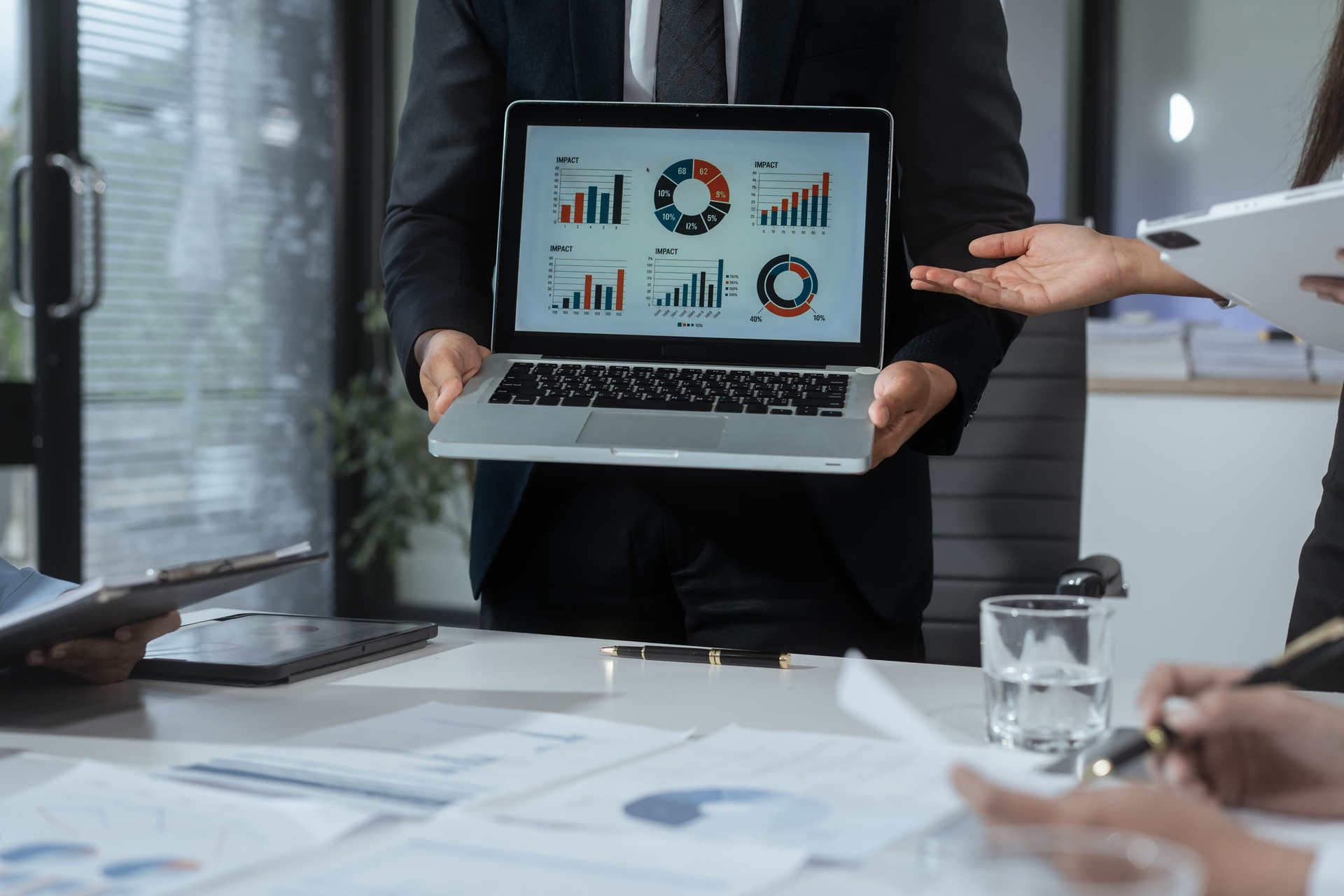Entrepreneurs, marketers, managers, and financial analysts gather around the table to analyze data, present results, plan strategies, discuss efficiencies,grow their businesses through collaboration